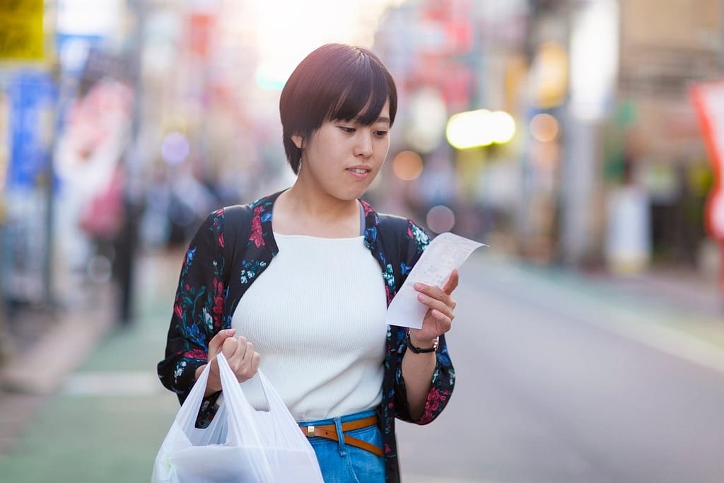 person with groceries and receipt NNaHY.width