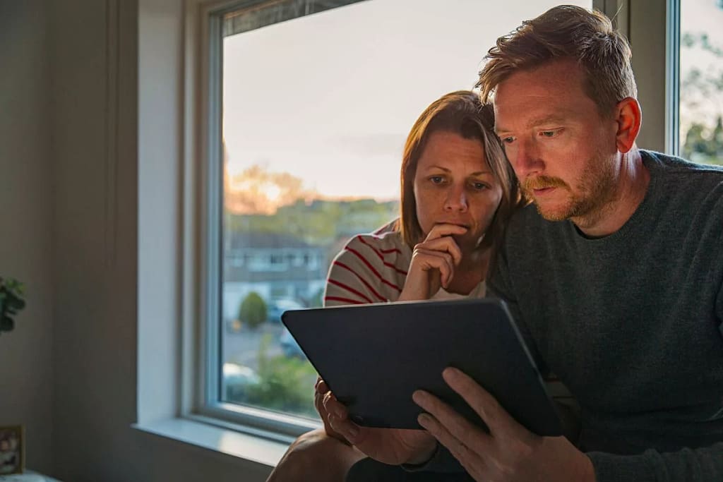 Worried looking couple looking at a tablet to.width omrJse.jpg