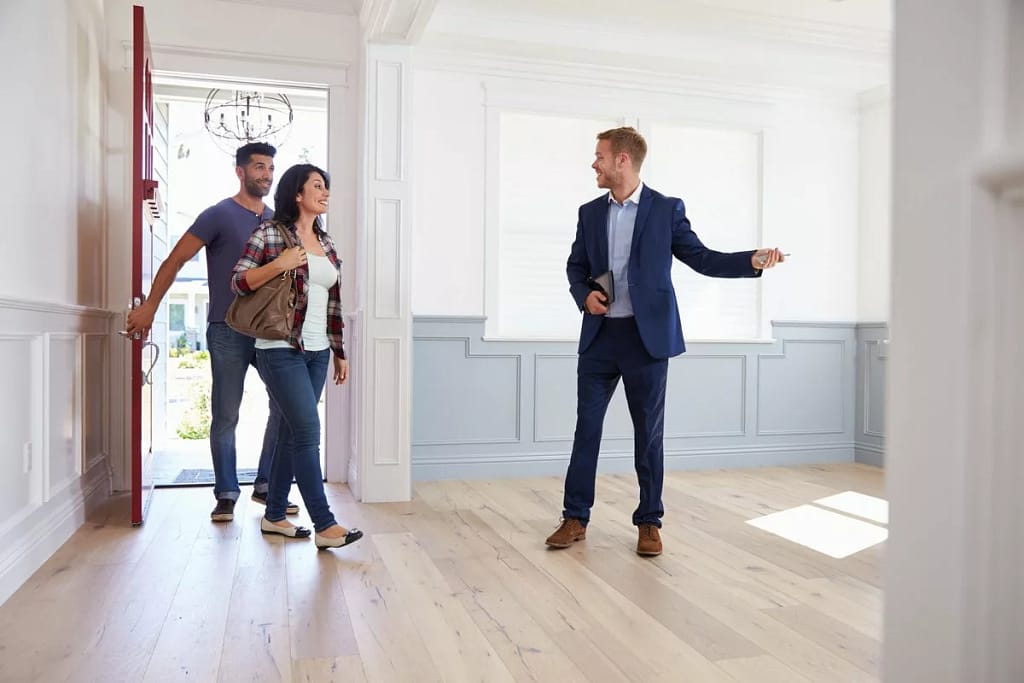 couple viewing house with realtor.width .jpg