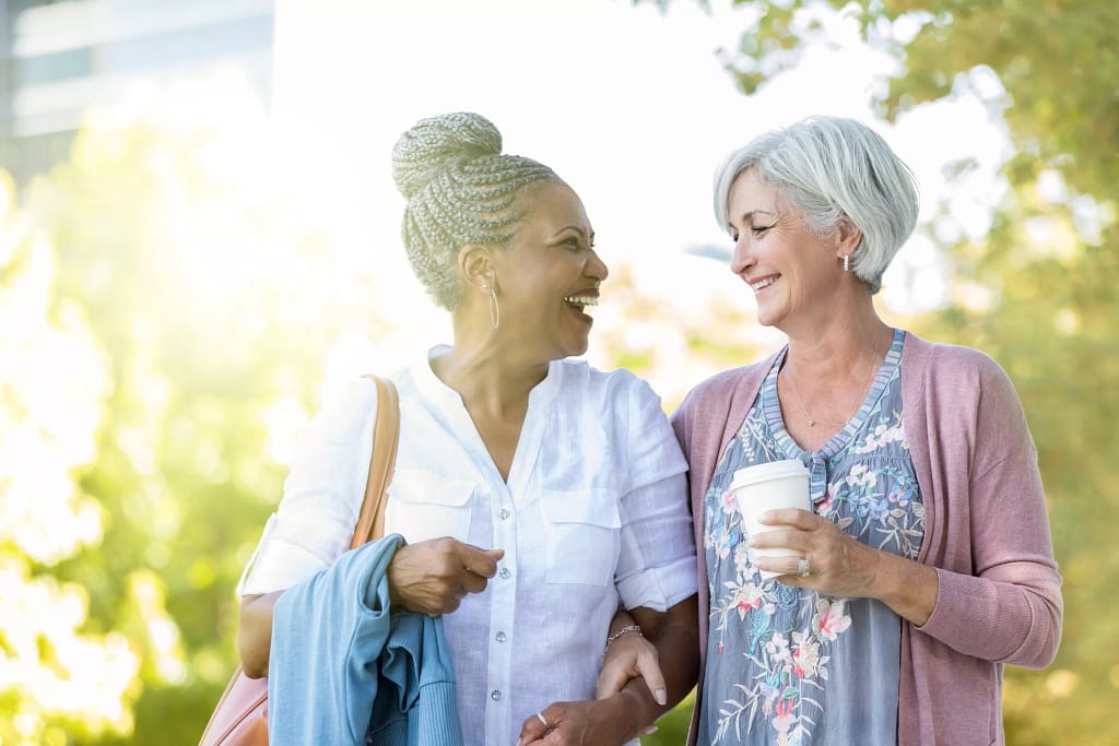 two older people walking outside smiling.jpg