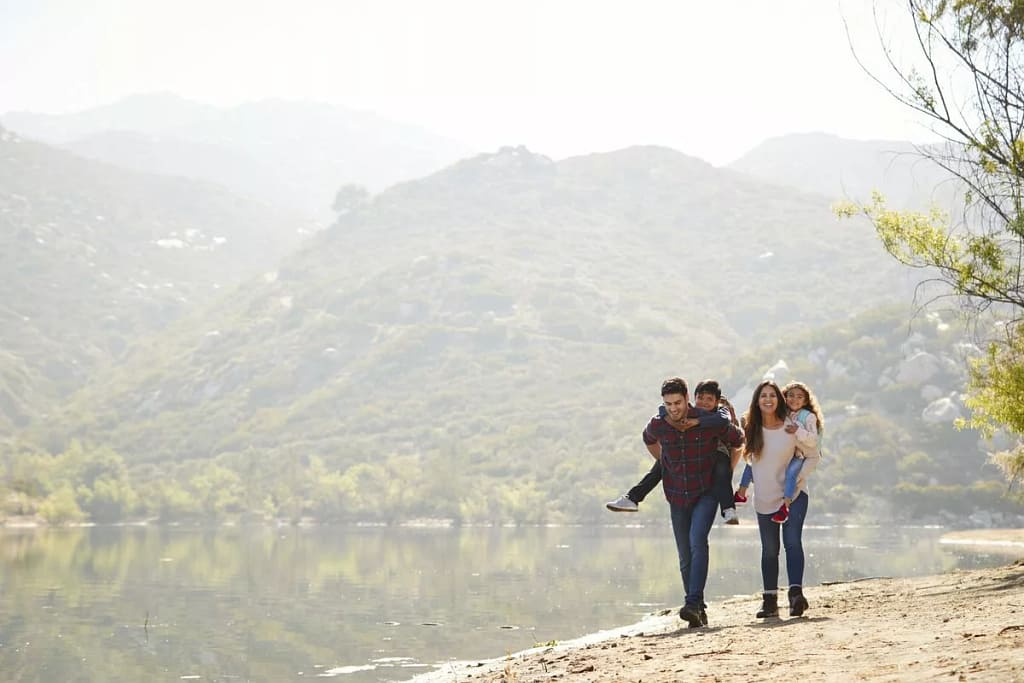 parents carrying young kids on hike bRydz.width .jpg