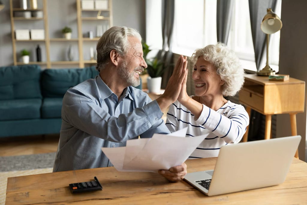 retired couple reviewing finances on a laptop.jpg