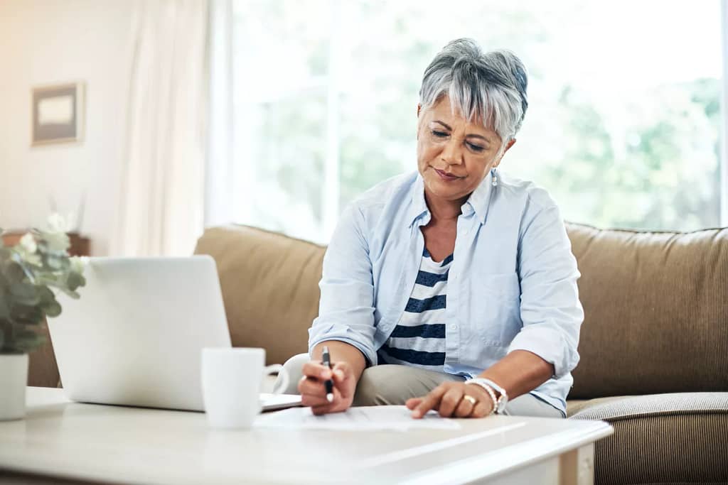 person holding pen and looking at document on coffee table.jpg