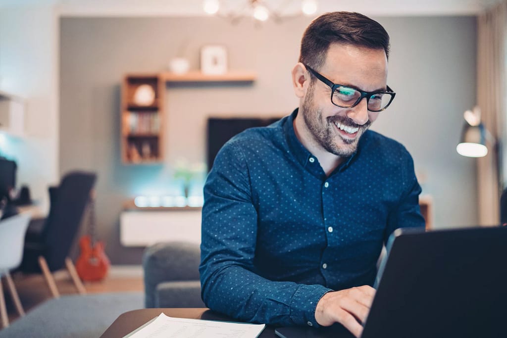 man s smiling laptop gettyimages .jpg