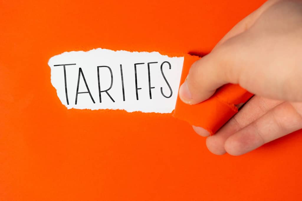 tariffs on torn orange paper.jpg