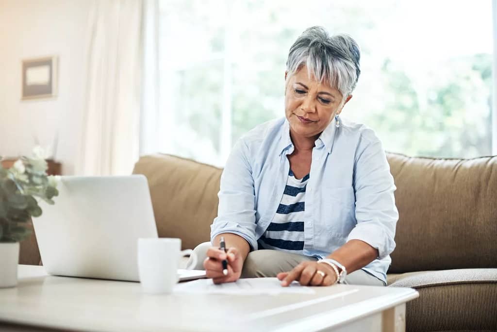 person with papers and laptop DbLKs.width .jpg
