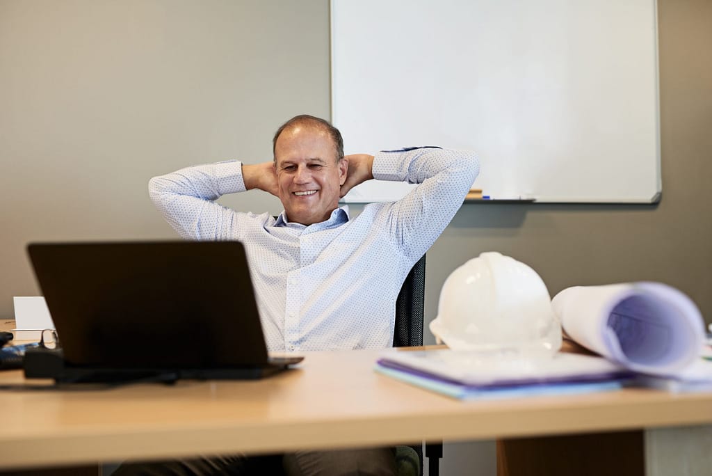 man s desk smiling gettyimages .jpg