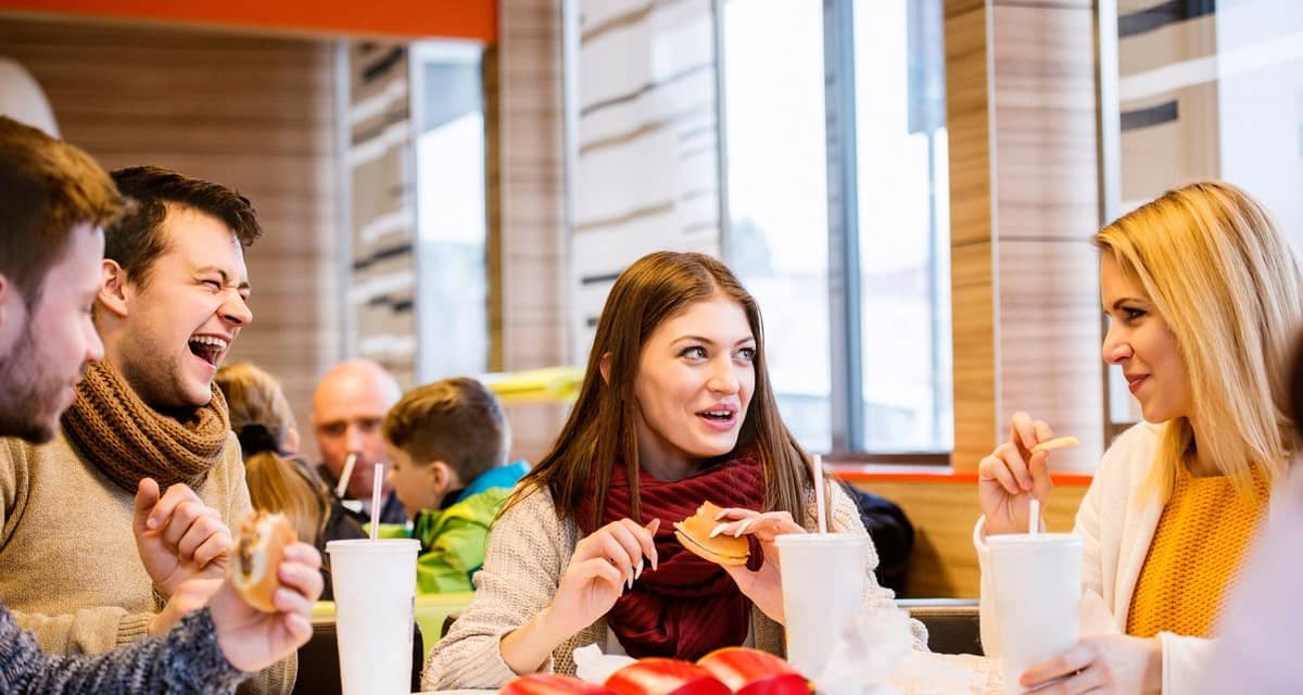 Group of friends eating fast food burgers and.width .jpg