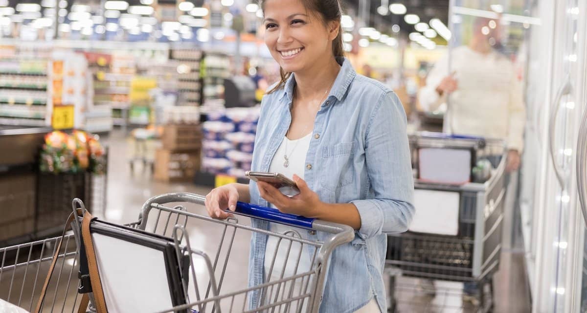 Smiling warehouse store club shopper with pho.width