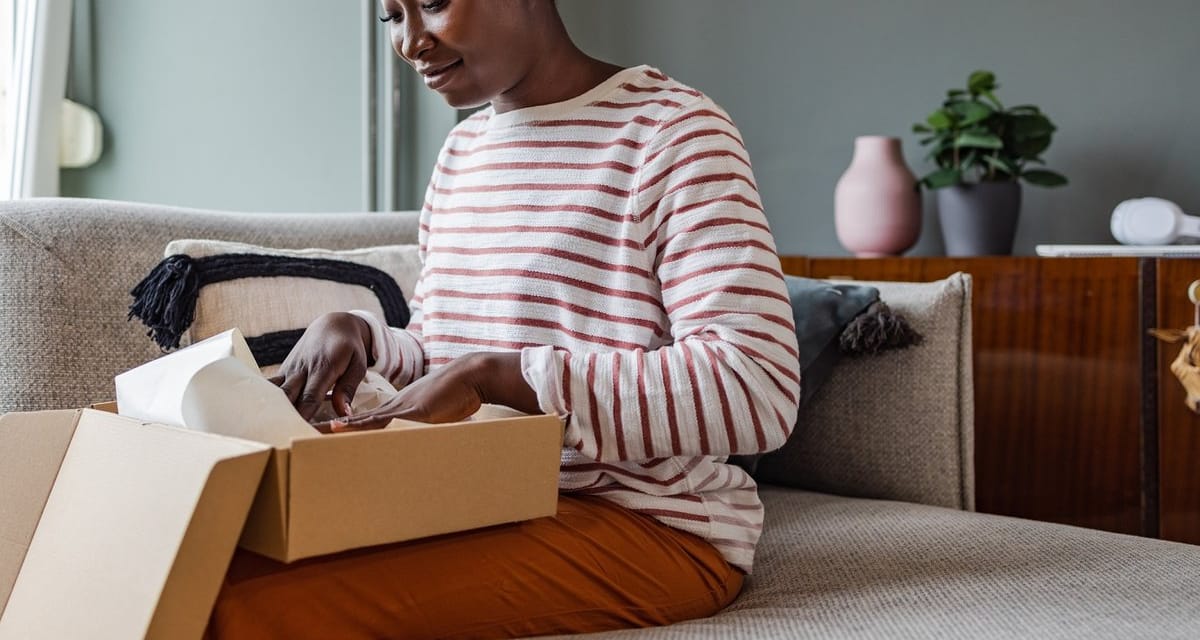 Woman packing up box to return item. juBzvHy.width