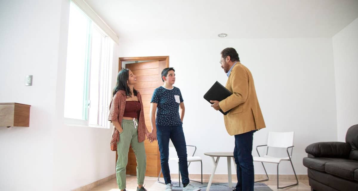 two people in living room with realtor DWhvec.width