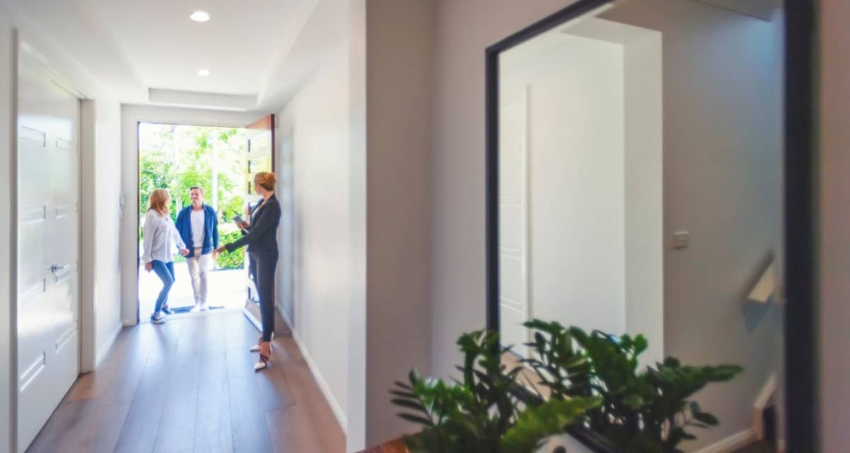 two people walking into house with realtor hd.width