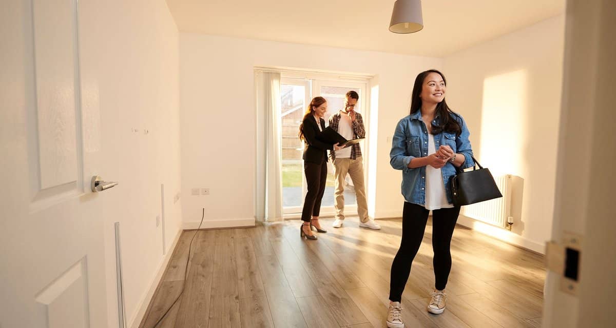 two people with realtor in empty house NVSf.width