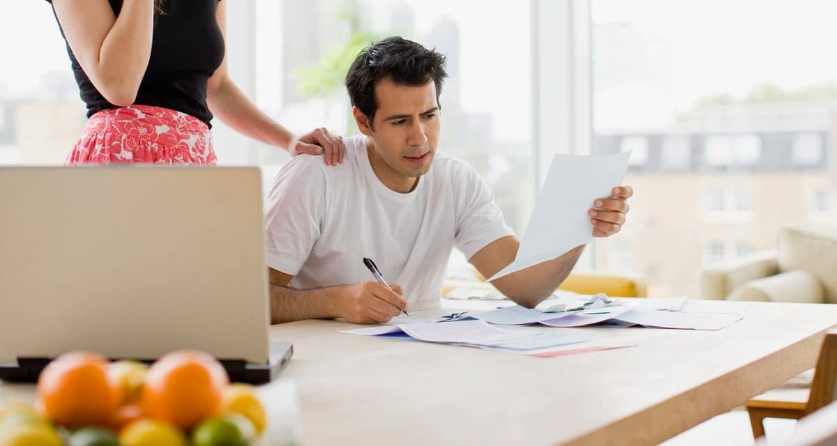 two worried people at kitchen table with bill.width MIUbkr