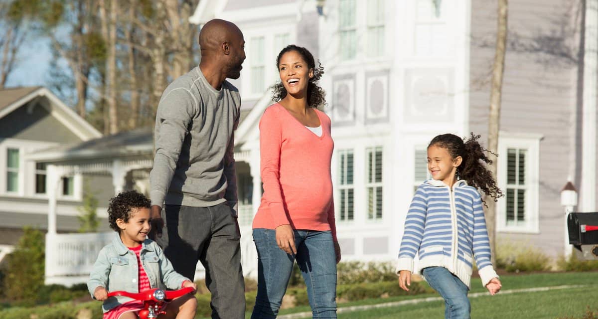 Family walking through suburban neighborhood .width .jpg