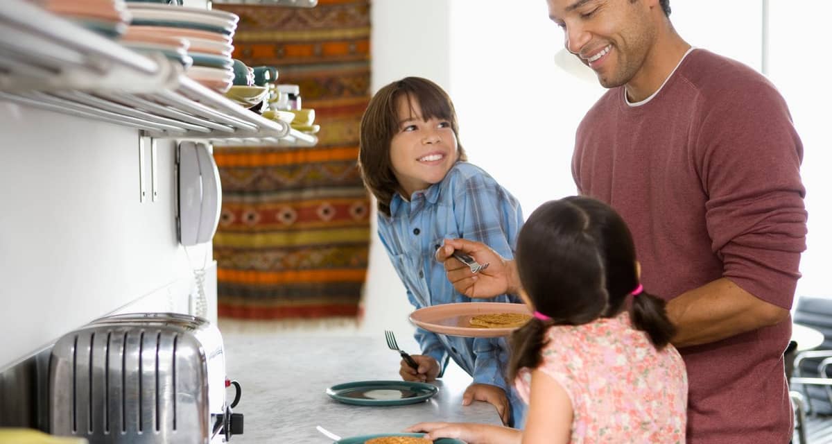 Father in kitchen with kids making breakfast .width .jpg