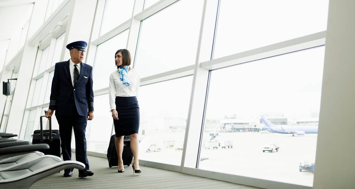 Pilot and flight attendant walking to airport.width LhaGV.jpg