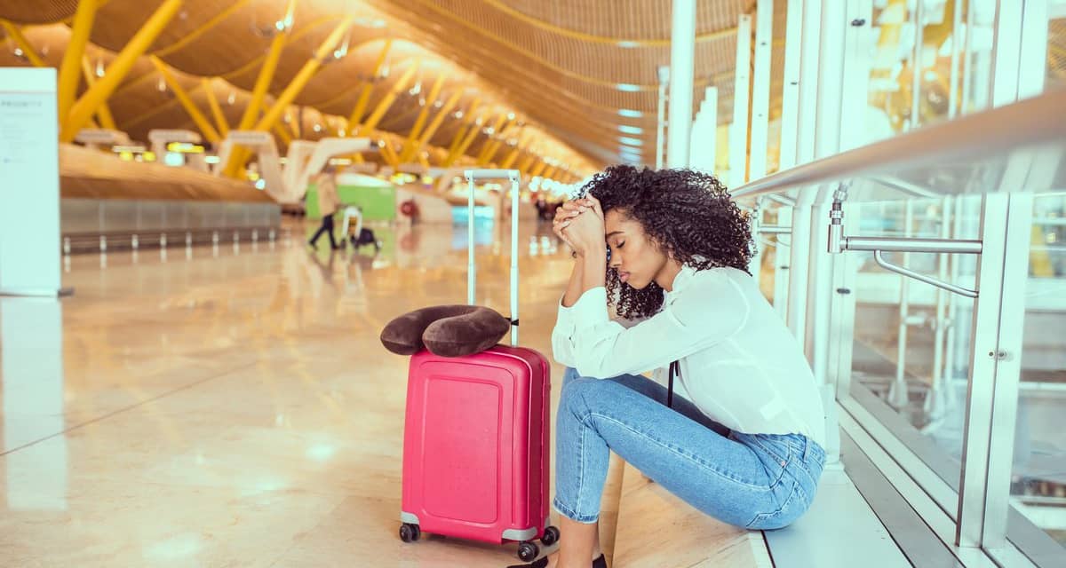 Upset woman at airport eSPPDv.width .jpg