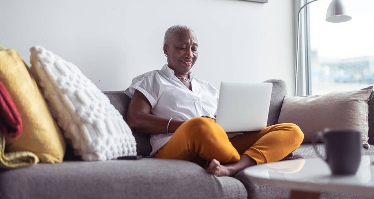 older adult on couch with laptop nNXo.width .jpg