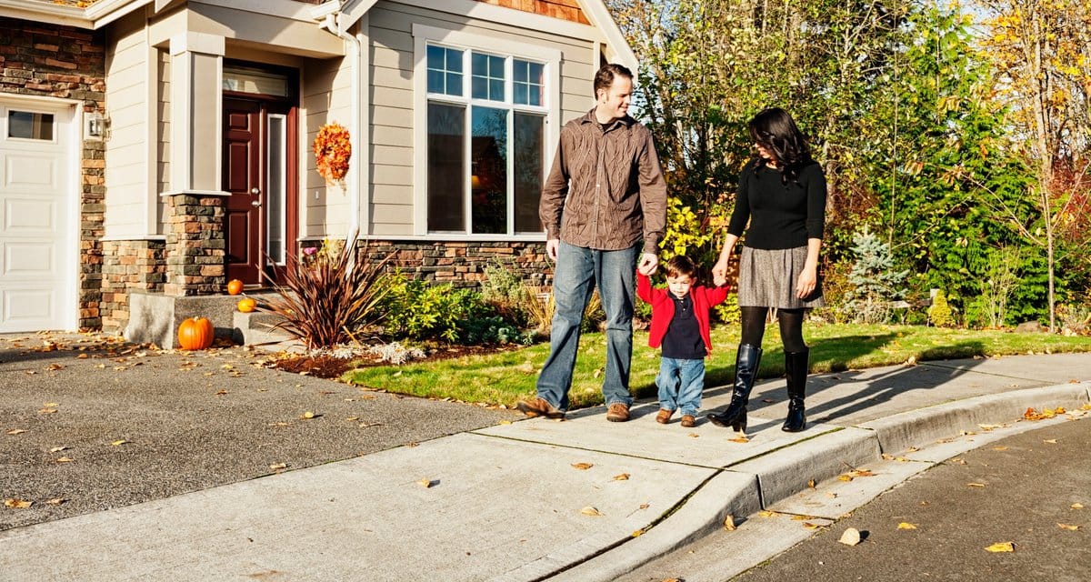 parents and child walking outside house lzHs.width .jpg