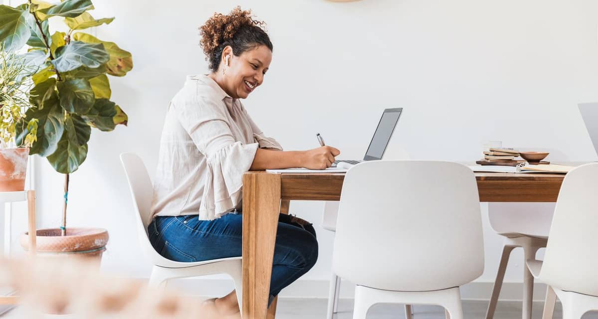 person at dining table writing in notebook TR.width .jpg