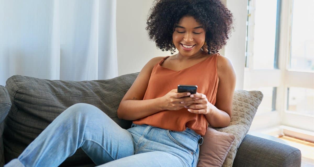 person on couch with phone TIHLN.width .jpg