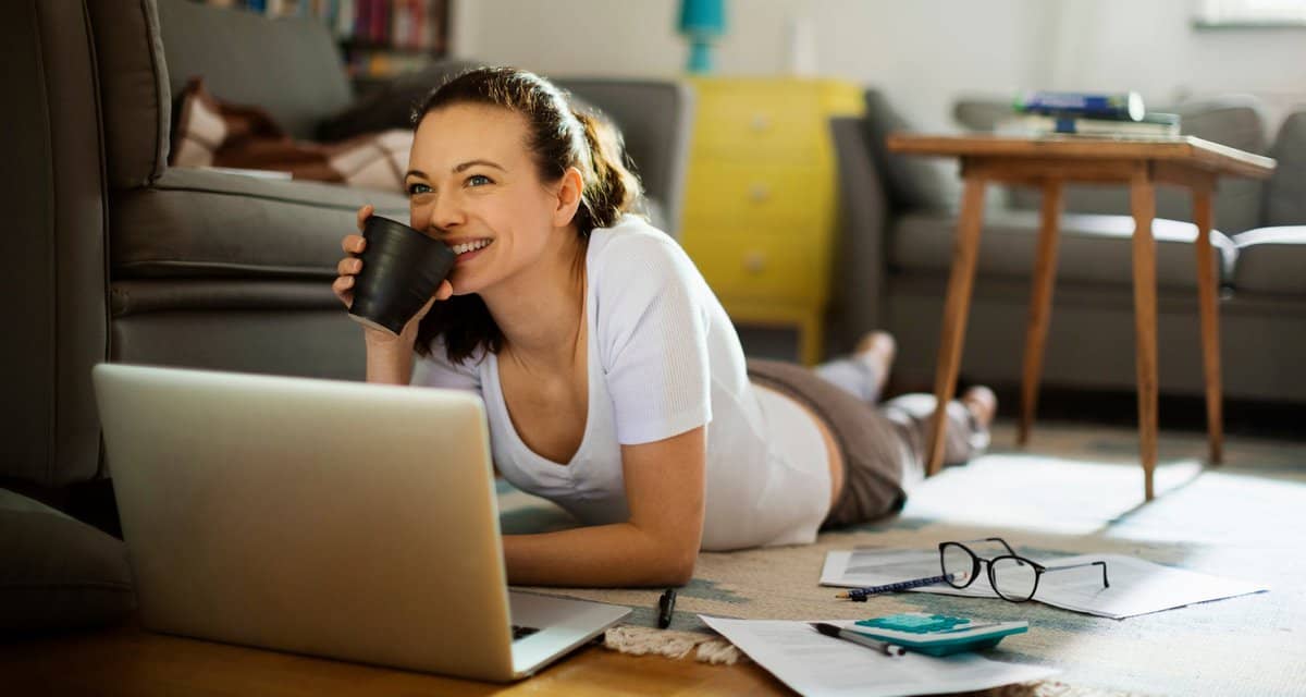 Woman pauses paying bills to enjoy coffee k.width .jpg