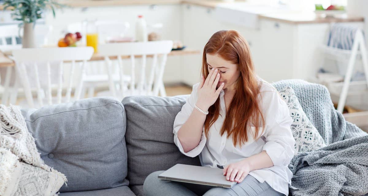 Woman rubbing the bridge of her nose appearin.width UGzXRBl.jpg