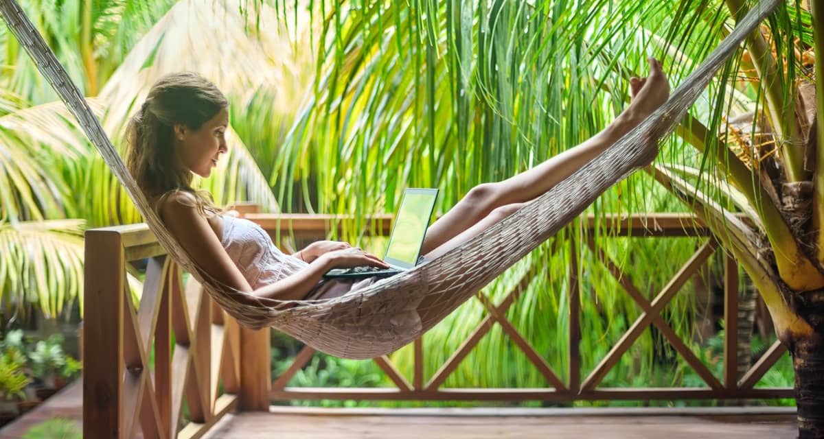 digital nomad using a laptop in a hammock sur.width XuhacNK.jpg
