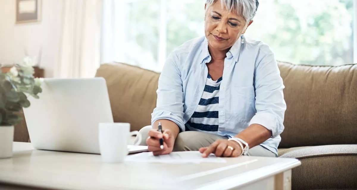person with papers and laptop DbLKs.width .jpg