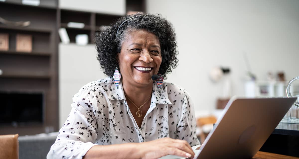 smiling person sitting in front of laptop.jpg