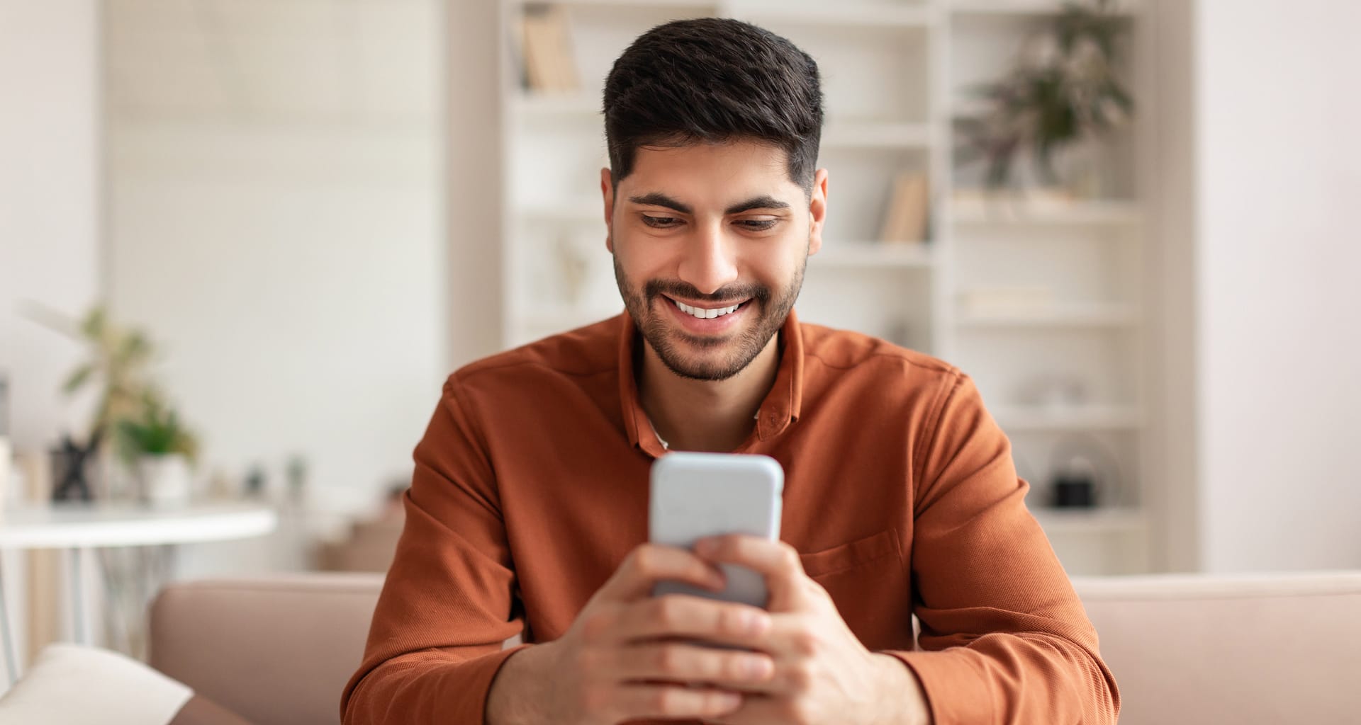 investor smiling phone at home cMrY