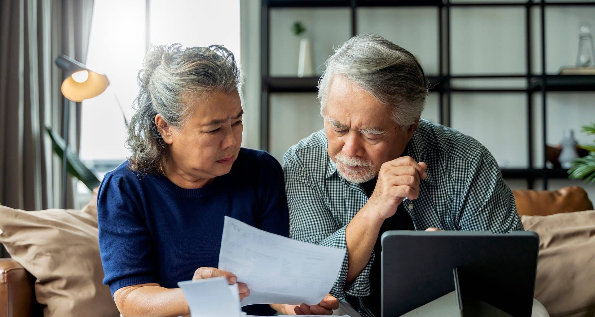people with concerned expressions looking at document