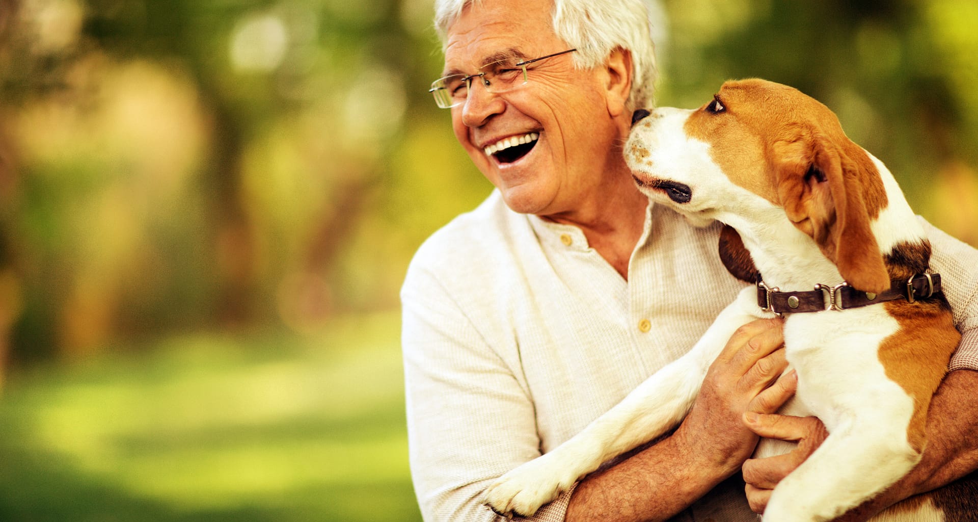 senior man smiling being licked by dog gettyimages .jpg