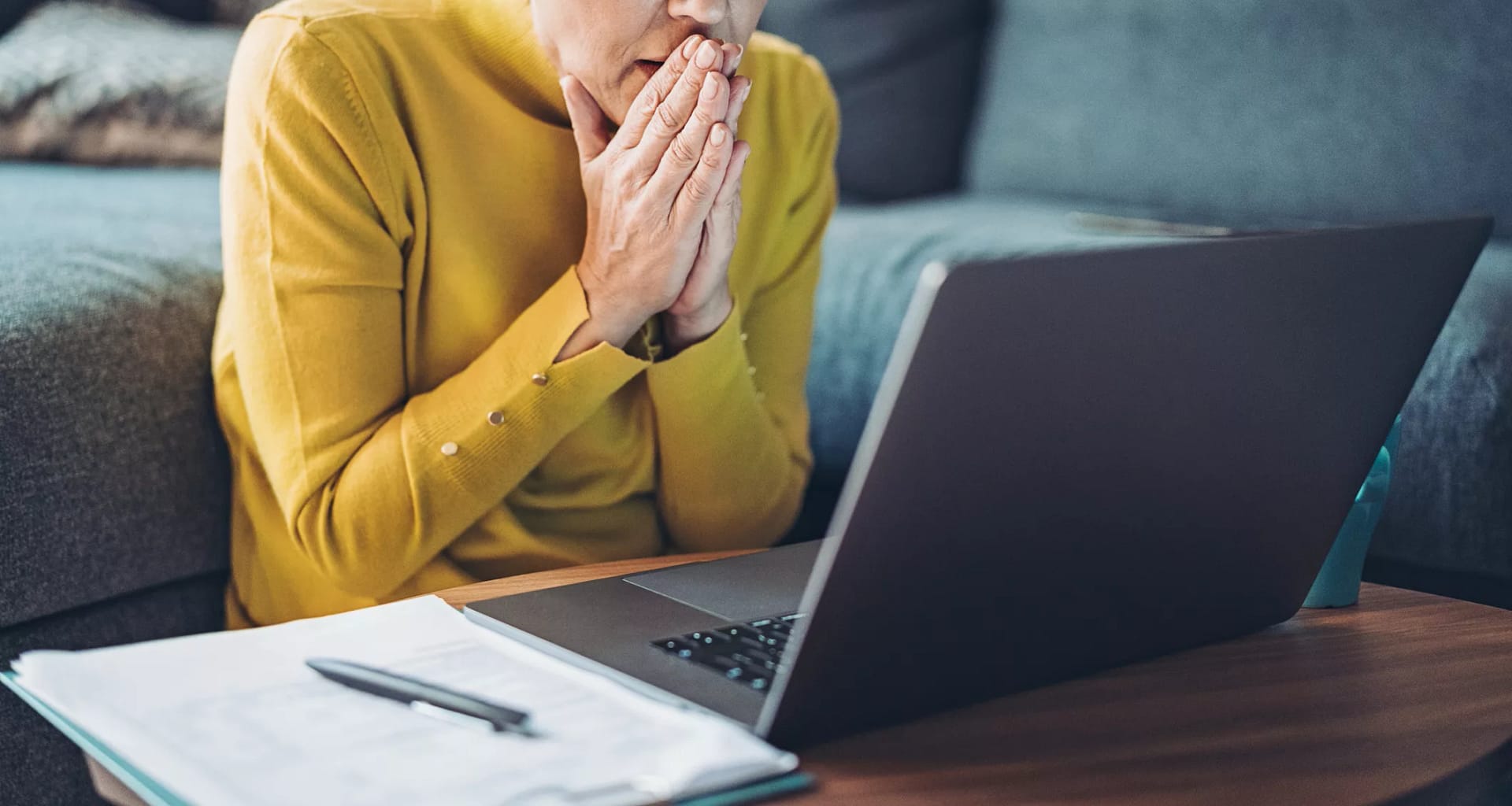 mature woman looking at computer in shock.jpg