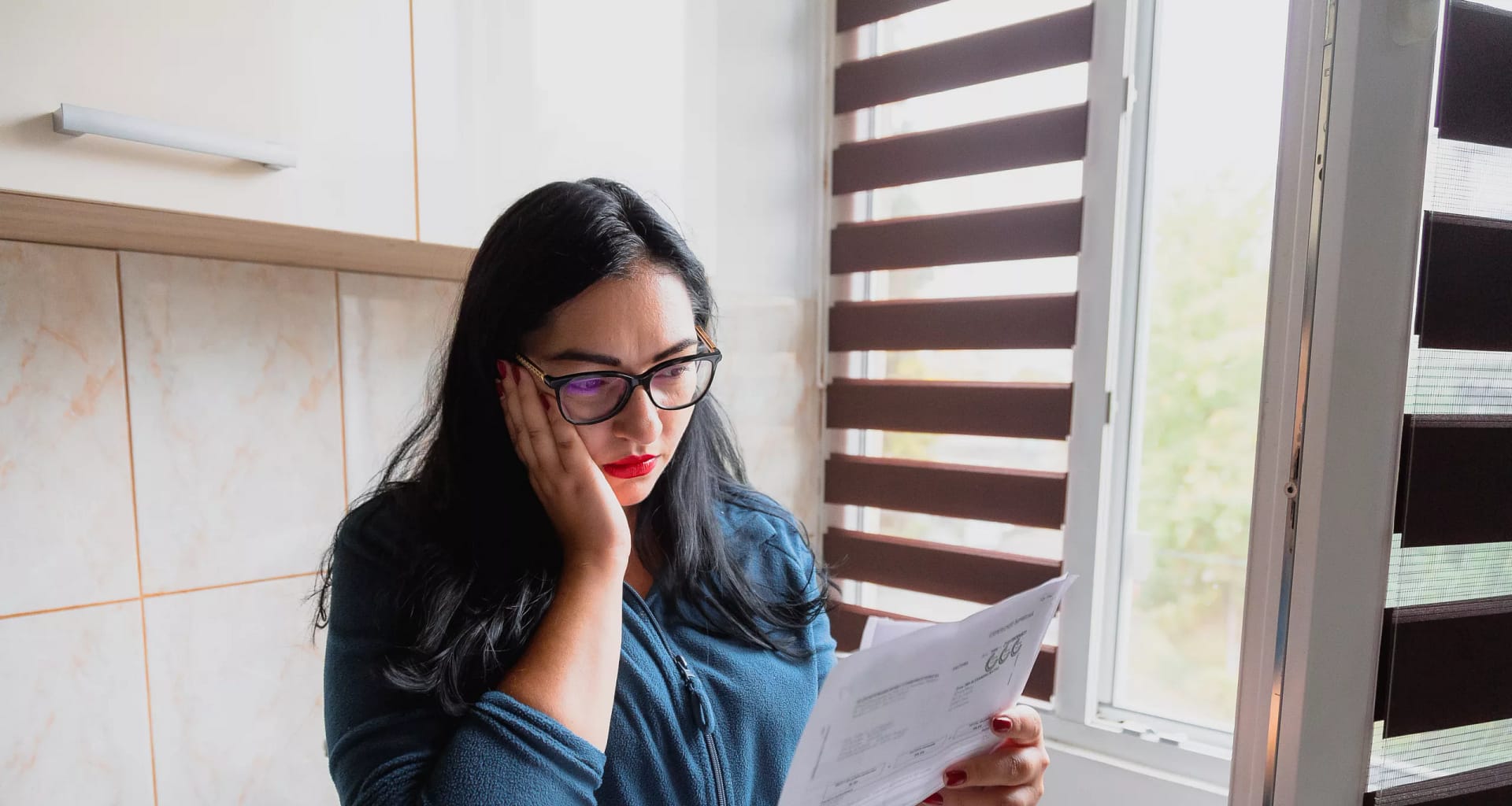 stressed businesswoman reviewing papers.jpg
