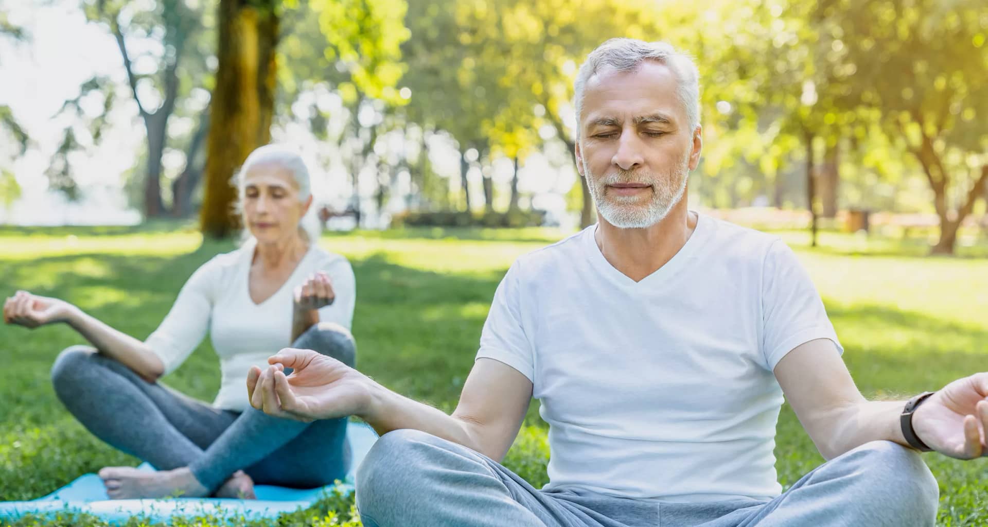 getty two people doing yoga or meditating outside health exercise.jpg
