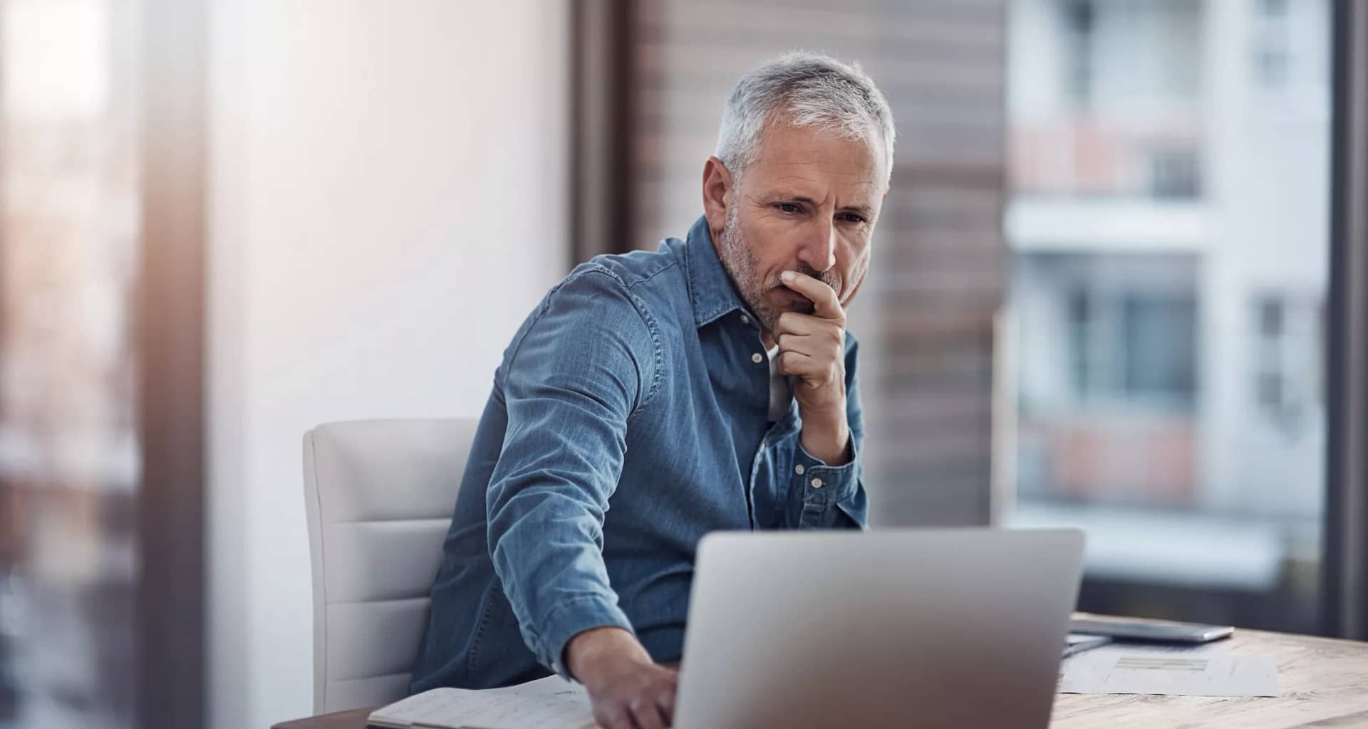 older man denim shirt laptop gettyimages .jpg