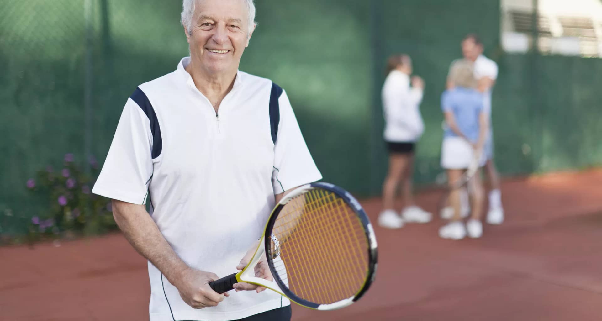 older man holding tennis racket gettyimages .jpg
