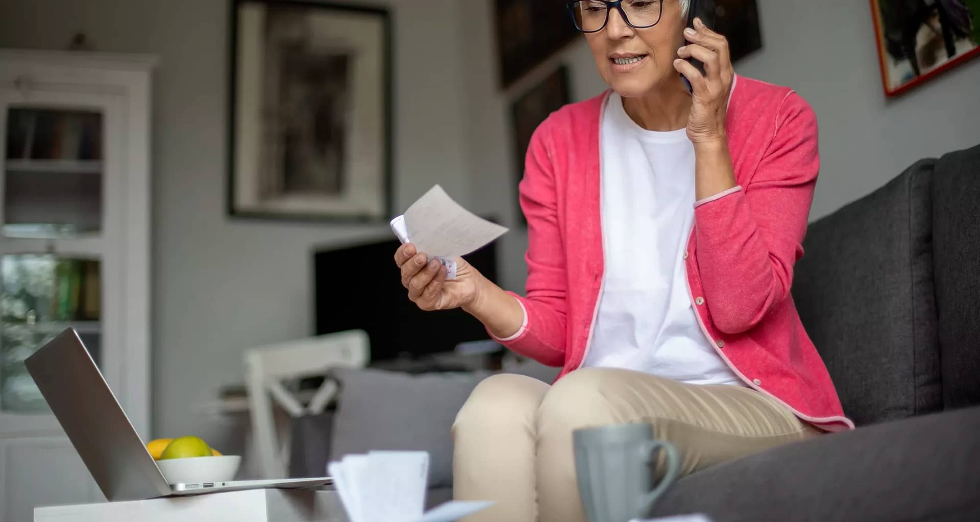 senior holding check and talking on phone.jpg