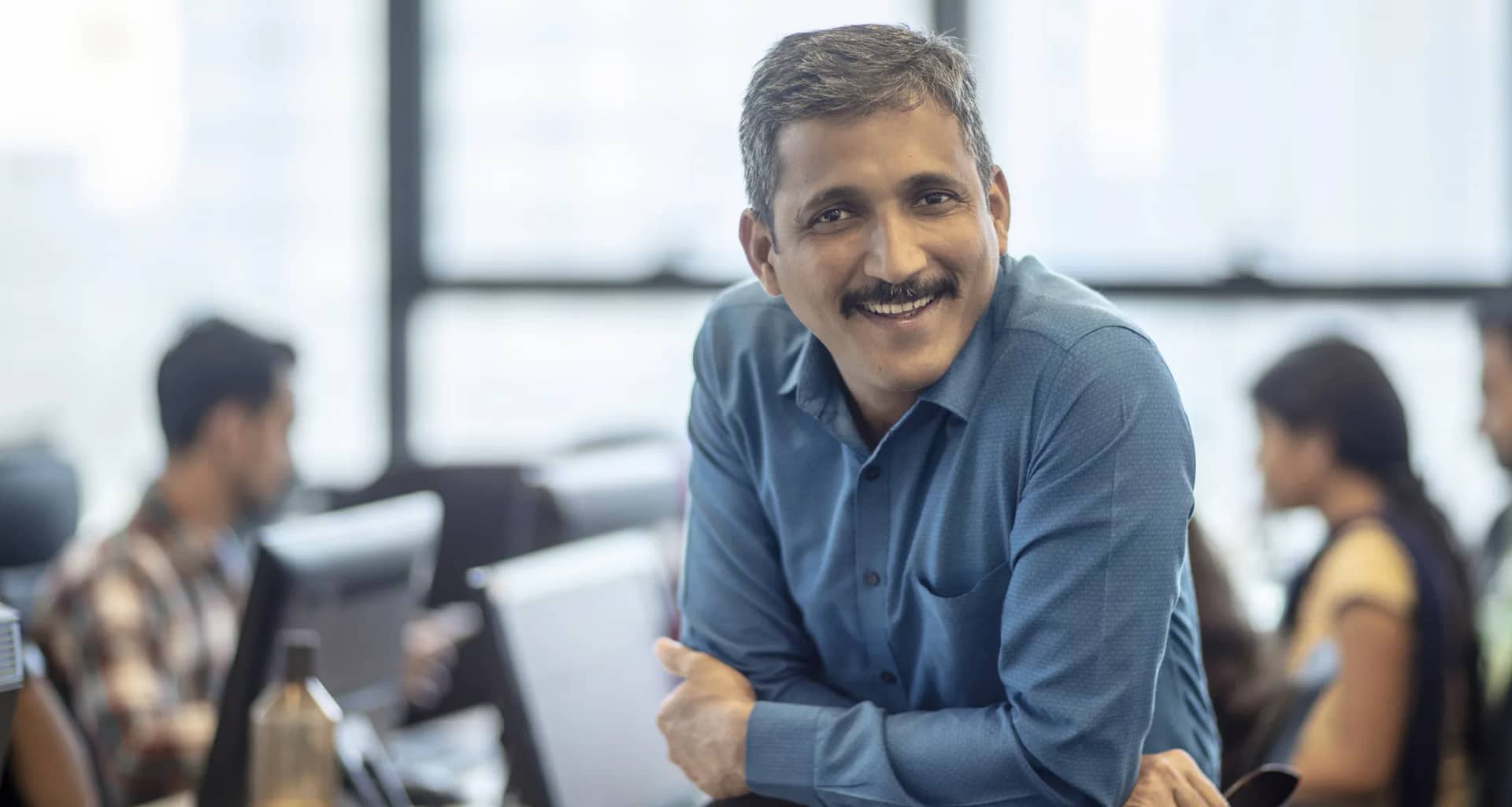 getty happy smiling business person at office.jpg