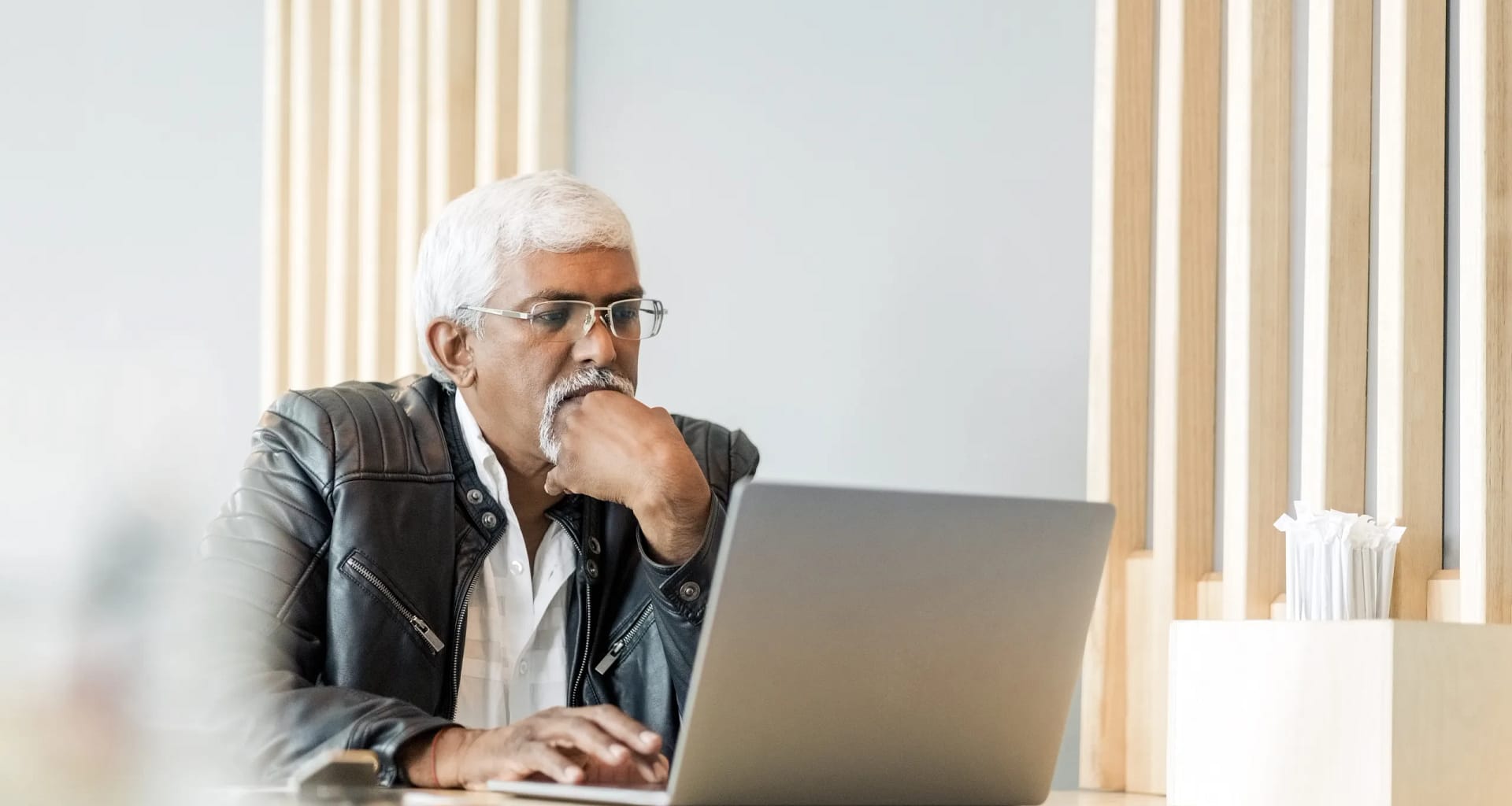 retired older man on laptop working reading news stocks.jpg