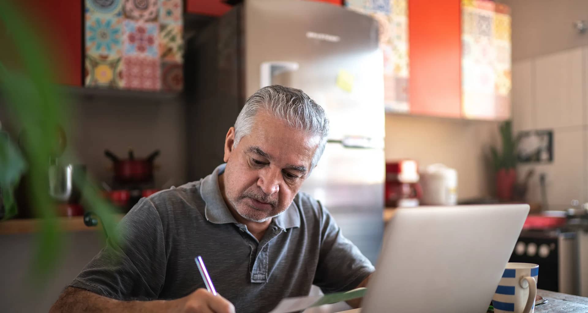 senior man laptop taking notes gettyimages .jpg