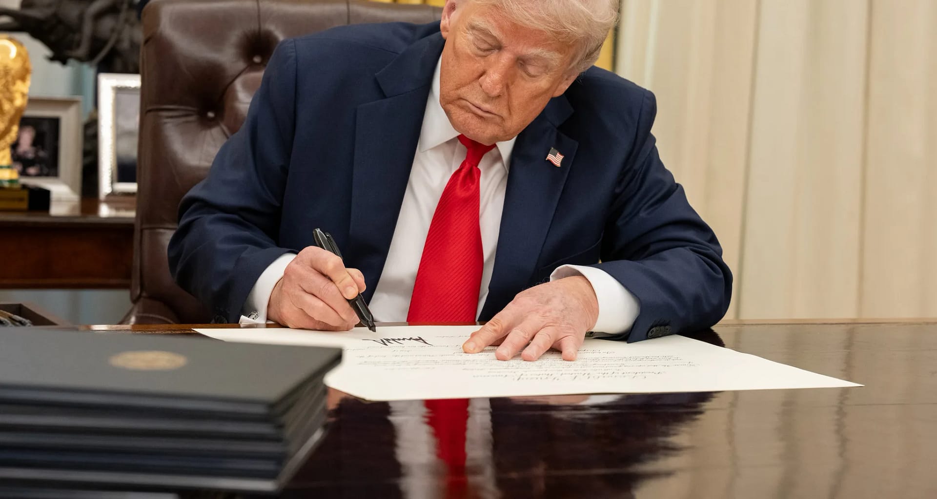 white house president donald trump signing executive order at resolute desk in oval office.jpg