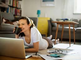 Woman pauses paying bills to enjoy coffee k.width .jpg
