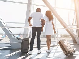 two people with suitcases holding hands hNDS.width .jpg