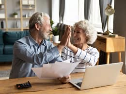 retired couple reviewing finances on a laptop.jpg