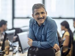 getty happy smiling business person at office.jpg
