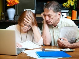senior couple worried looking at bills finances debt.jpg