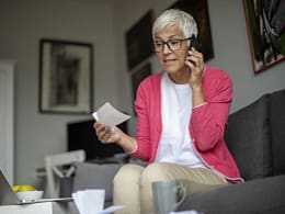 senior holding check and talking on phone.jpg